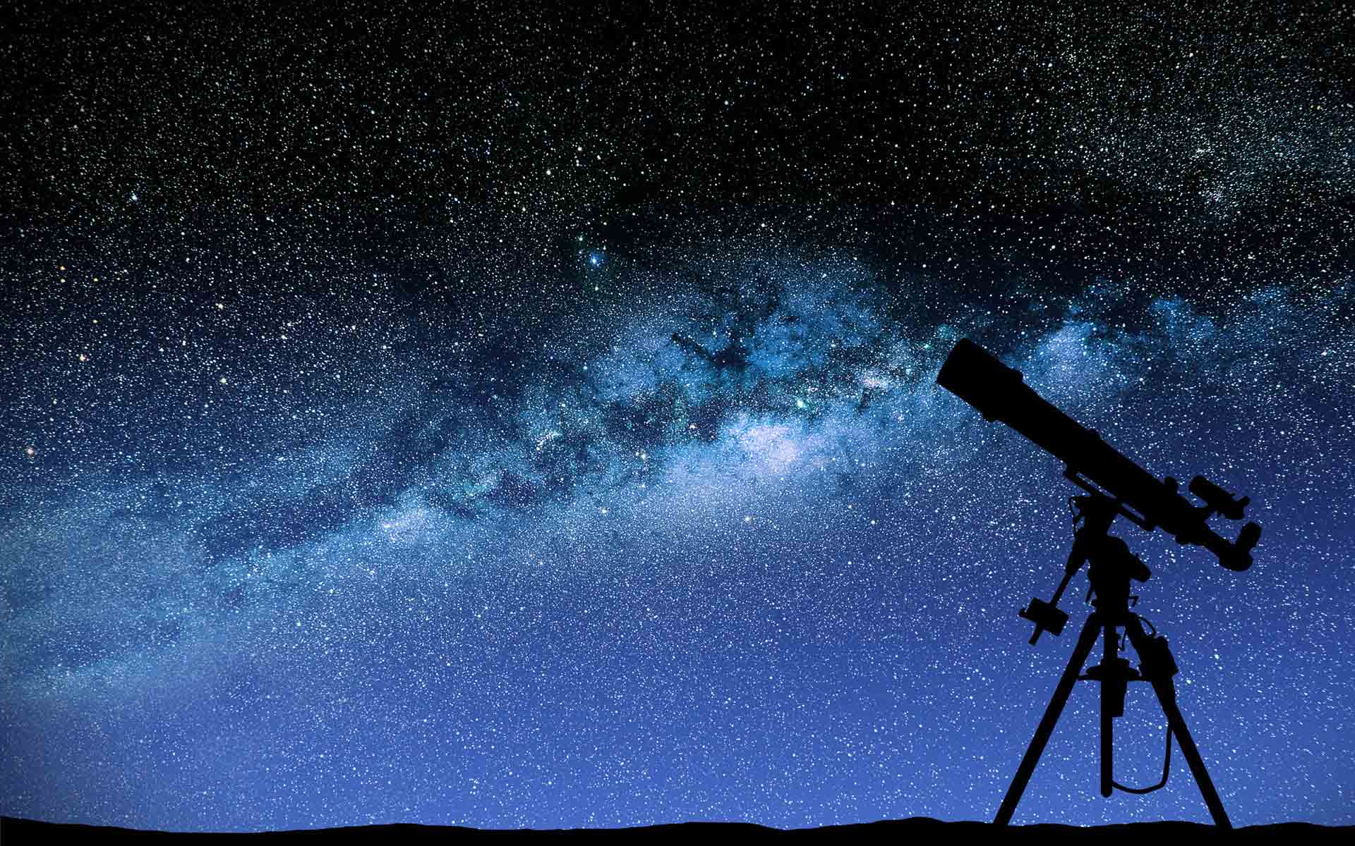 An image of a starry sky and a telescope